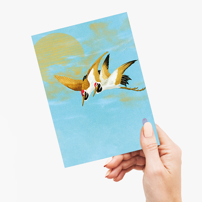 Two sarus crane flying in front of the moon - Greeting Card